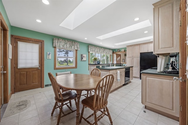 4324 C Ave NE, Cedar Rapids, IA 52402 - dining space with a skylight, light tile patterned flooring, and recessed lighting