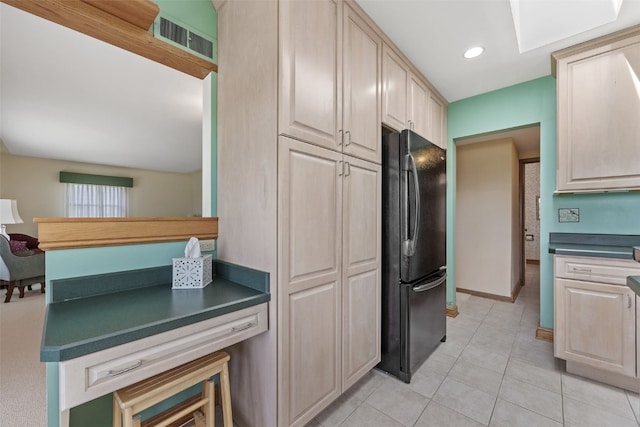 4324 C Ave NE, Cedar Rapids, IA 52402 - kitchen with freestanding refrigerator, dark countertops, light tile patterned floors, light brown cabinets, and recessed lighting