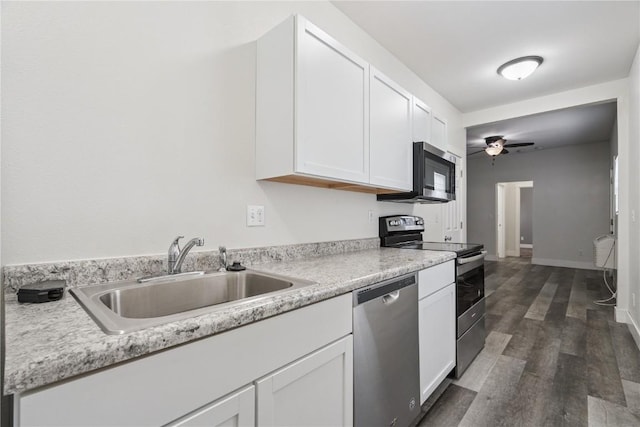 208 Northgate St, Shellsburg, IA 52332 - kitchen with stainless steel appliances, white cabinetry, ceiling fan, light countertops, and dark wood finished floors