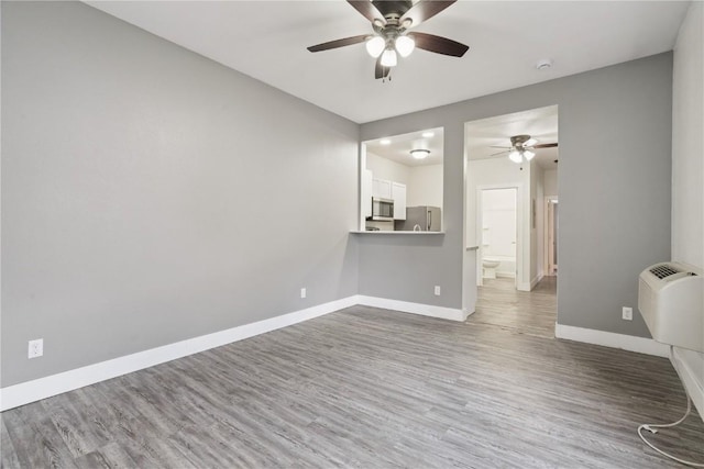 208 Northgate St, Shellsburg, IA 52332 - unfurnished living room featuring ceiling fan and wood finished floors