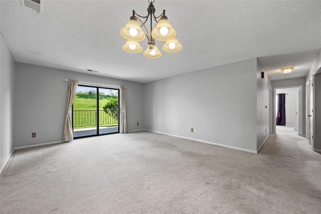 2131 1st Ave SE Unit 116, Cedar Rapids, IA 52403 - empty room featuring carpet floors, a textured ceiling, a chandelier, and baseboards