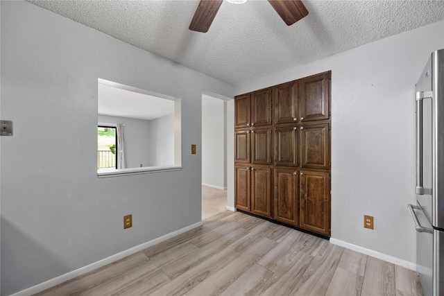 2131 1st Ave SE Unit 116, Cedar Rapids, IA 52403 - unfurnished bedroom featuring high quality fridge, light wood-type flooring, a textured ceiling, baseboards, and ceiling fan