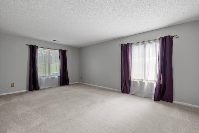 2131 1st Ave SE Unit 116, Cedar Rapids, IA 52403 - carpeted spare room featuring a textured ceiling and baseboards