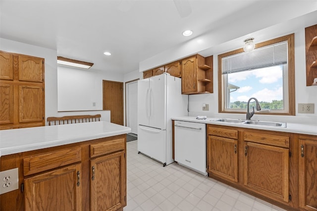 1782 Baker Ave, West Branch, IA 52358 - kitchen with white appliances, brown cabinetry, light countertops, light floors, and recessed lighting