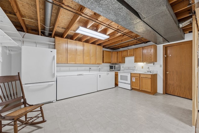 1782 Baker Ave, West Branch, IA 52358 - kitchen with white appliances, washer / dryer, light countertops, and light floors