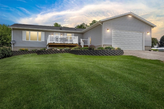 1782 Baker Ave, West Branch, IA 52358 - view of front of property featuring a front lawn, driveway, a wooden deck, and an attached garage