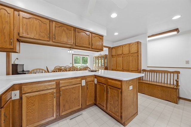 1782 Baker Ave, West Branch, IA 52358 - kitchen featuring ceiling fan, brown cabinets, light countertops, light floors, and recessed lighting
