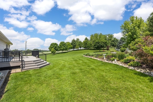 1782 Baker Ave, West Branch, IA 52358 - view of green lawn with a wooden deck