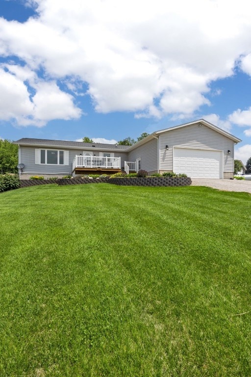 1782 Baker Ave, West Branch, IA 52358 - view of front of home with an attached garage, driveway, a front yard, and a deck