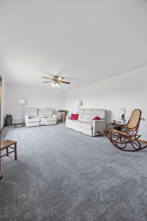 1782 Baker Ave, West Branch, IA 52358 - living area featuring carpet floors and a ceiling fan