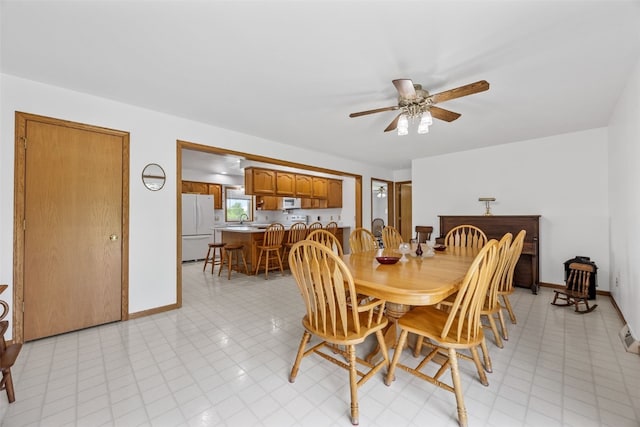 1782 Baker Ave, West Branch, IA 52358 - dining room featuring a ceiling fan and baseboards