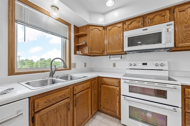1782 Baker Ave, West Branch, IA 52358 - kitchen featuring white appliances, brown cabinetry, light countertops, and open shelves