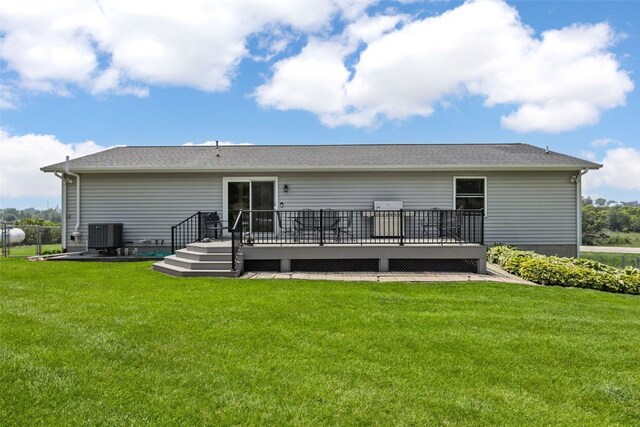 1782 Baker Ave, West Branch, IA 52358 - rear view of house featuring a wooden deck and a lawn