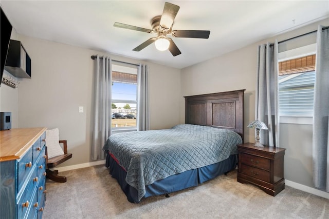452 Lewellen Dr NW, Cedar Rapids, IA 52405 - bedroom with light carpet, baseboards, and ceiling fan