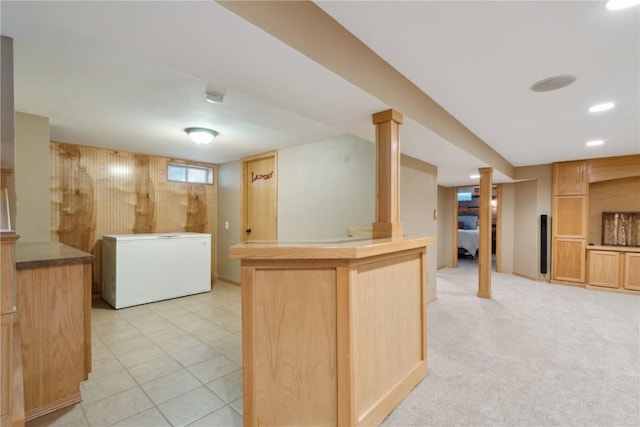 452 Lewellen Dr NW, Cedar Rapids, IA 52405 - kitchen featuring fridge, light brown cabinetry, and a peninsula