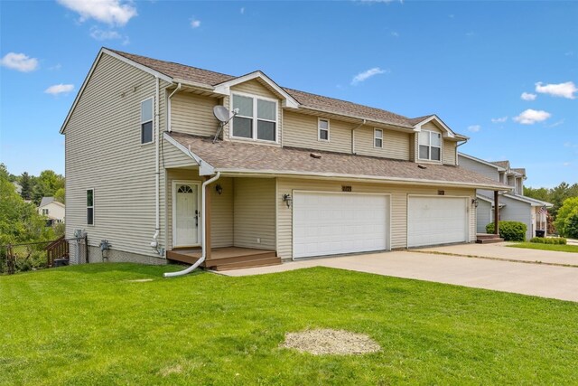 2273 Holiday Rd, Coralville, IA 52241 - townhome / multi-family property with an attached garage, concrete driveway, and a shingled roof