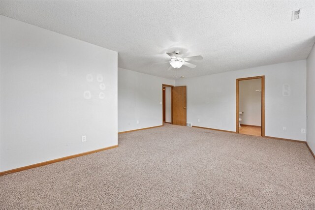 2273 Holiday Rd, Coralville, IA 52241 - spare room with a ceiling fan, baseboards, light carpet, and a textured ceiling