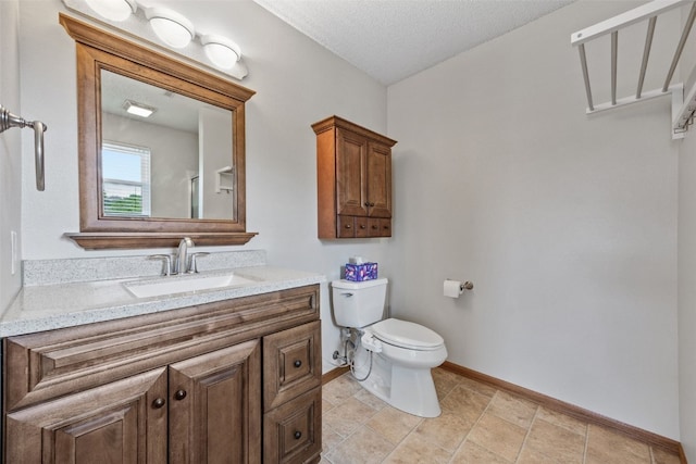 2273 Holiday Rd, Coralville, IA 52241 - bathroom featuring toilet, vanity, baseboards, and a textured ceiling
