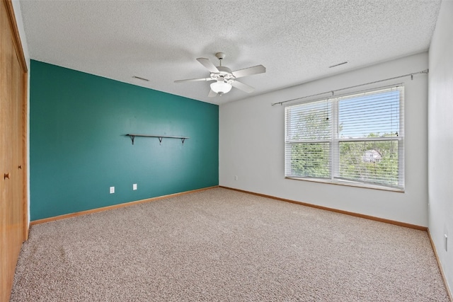 2273 Holiday Rd, Coralville, IA 52241 - unfurnished room with carpet floors, a ceiling fan, a textured ceiling, and baseboards
