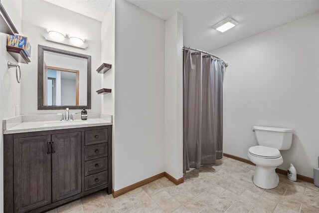 2273 Holiday Rd, Coralville, IA 52241 - full bath with vanity, toilet, curtained shower, baseboards, and a textured ceiling
