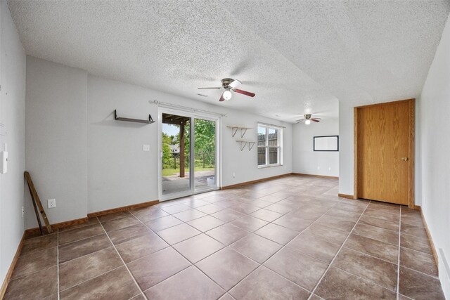 2273 Holiday Rd, Coralville, IA 52241 - tiled empty room featuring a ceiling fan, a textured ceiling, and baseboards