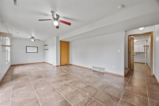 2273 Holiday Rd, Coralville, IA 52241 - spare room featuring a ceiling fan, a textured ceiling, light tile patterned floors, a smoke detector, and baseboards