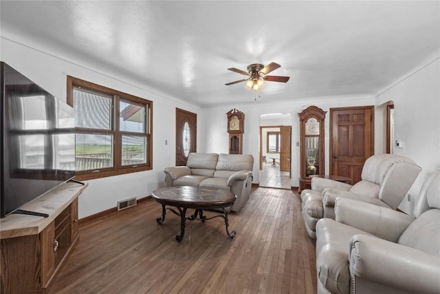 3152 66th St, Shellsburg, IA 52332 - living room with arched walkways, ceiling fan, hardwood / wood-style flooring, and baseboards