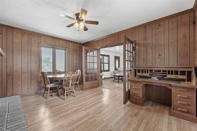 3152 66th St, Shellsburg, IA 52332 - dining room with wood walls, light wood finished floors, ceiling fan, a textured ceiling, and french doors