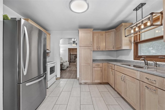 3152 66th St, Shellsburg, IA 52332 - kitchen with freestanding refrigerator, light brown cabinetry, white range with electric cooktop, a sink, and a ceiling fan
