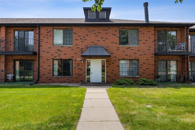 849 Kerry Ln SE Unit 49, Cedar Rapids, IA 52403 - townhome / multi-family property with a front lawn, brick siding, and roof with shingles