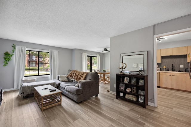 849 Kerry Ln SE Unit 49, Cedar Rapids, IA 52403 - living area featuring light wood finished floors, ceiling fan, and a textured ceiling