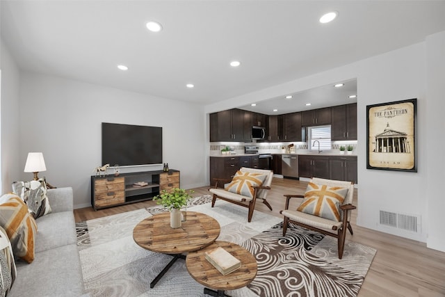 5208 Gordon Ave NW, Cedar Rapids, IA 52405 - living area featuring light wood-style floors, recessed lighting, and baseboards