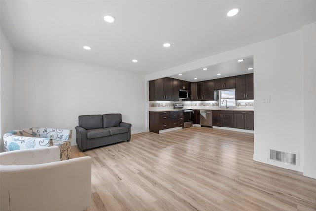 5208 Gordon Ave NW, Cedar Rapids, IA 52405 - living area with light wood-style floors, recessed lighting, and baseboards