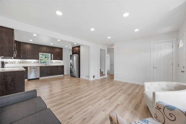 5208 Gordon Ave NW, Cedar Rapids, IA 52405 - living room with recessed lighting, stairway, light wood-type flooring, and baseboards