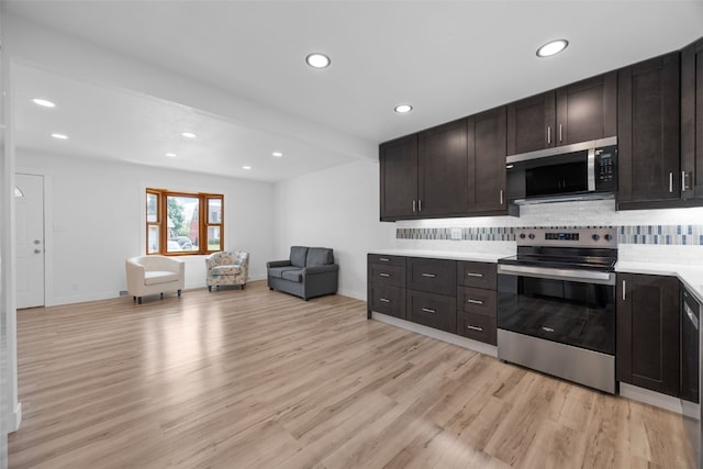 5208 Gordon Ave NW, Cedar Rapids, IA 52405 - kitchen with stainless steel appliances, recessed lighting, backsplash, light wood-style floors, and open floor plan