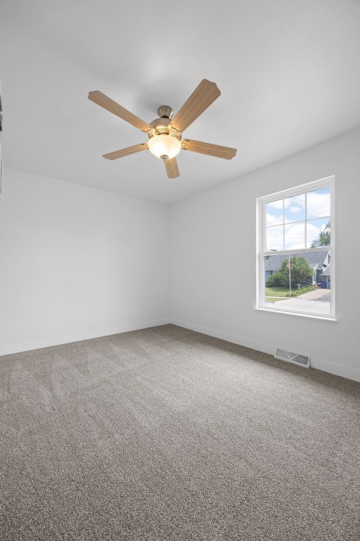 5208 Gordon Ave NW, Cedar Rapids, IA 52405 - carpeted spare room with baseboards and ceiling fan