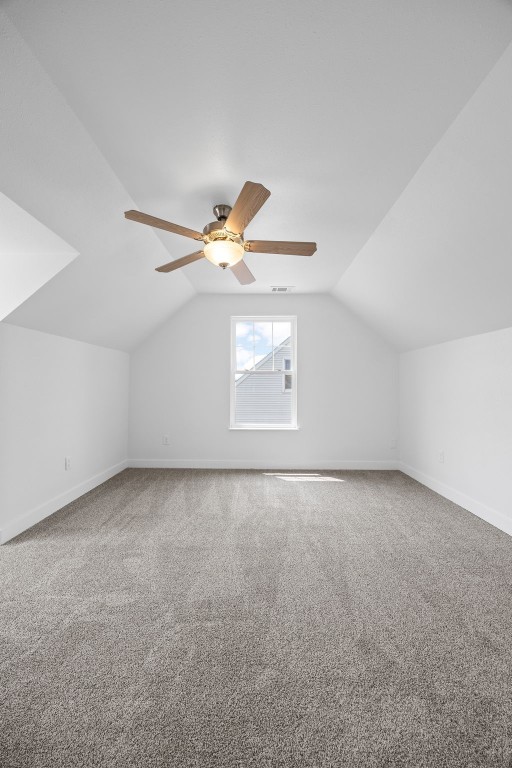 5208 Gordon Ave NW, Cedar Rapids, IA 52405 - bonus room with baseboards, vaulted ceiling, carpet floors, and ceiling fan