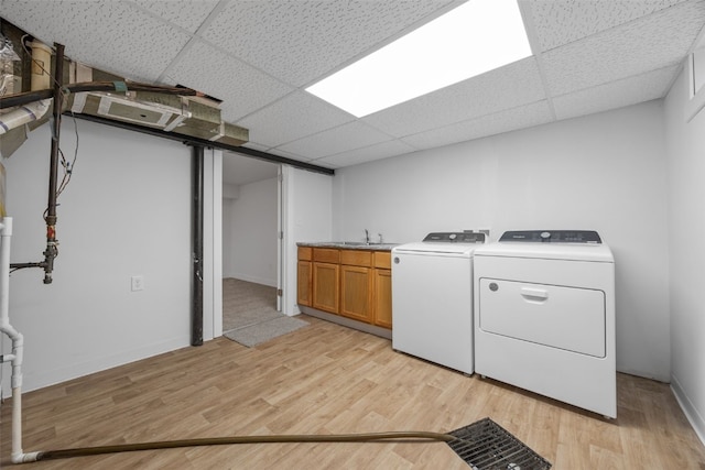 5208 Gordon Ave NW, Cedar Rapids, IA 52405 - laundry room featuring independent washer and dryer, cabinet space, light wood finished floors, and baseboards
