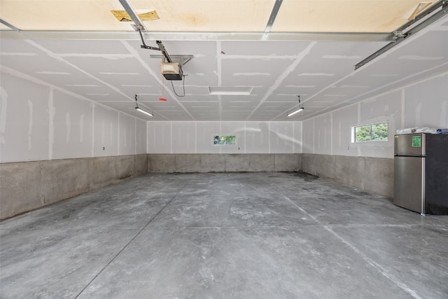 5208 Gordon Ave NW, Cedar Rapids, IA 52405 - garage featuring freestanding refrigerator and a garage door opener
