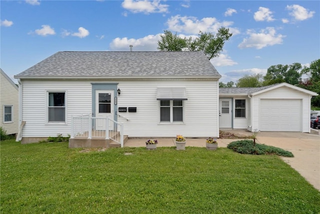 2241 Williams Blvd SW, Cedar Rapids, IA 52404 - view of front of house with an attached garage, concrete driveway, roof with shingles, and a front lawn