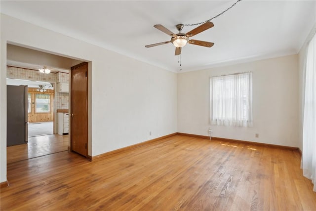 2241 Williams Blvd SW, Cedar Rapids, IA 52404 - spare room with a ceiling fan, baseboards, light wood-type flooring, and a chandelier