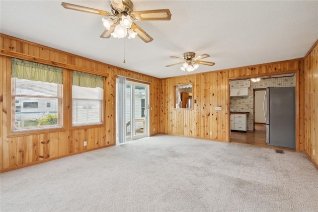2241 Williams Blvd SW, Cedar Rapids, IA 52404 - carpeted spare room with wooden walls and ceiling fan