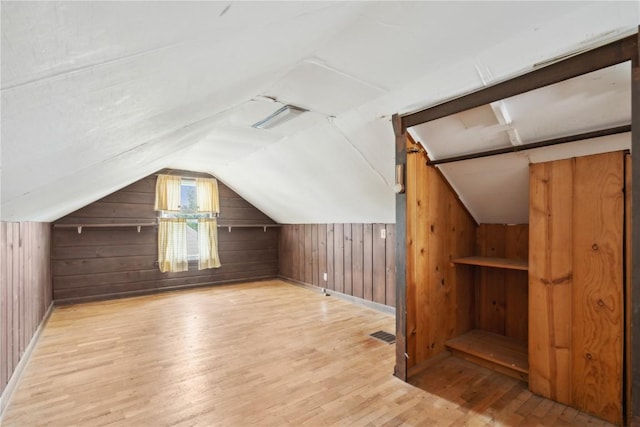 2241 Williams Blvd SW, Cedar Rapids, IA 52404 - bonus room featuring wood finished floors, wood walls, vaulted ceiling, and baseboards