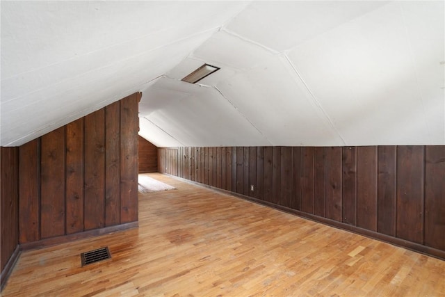 2241 Williams Blvd SW, Cedar Rapids, IA 52404 - additional living space with wood walls, vaulted ceiling, and wood finished floors