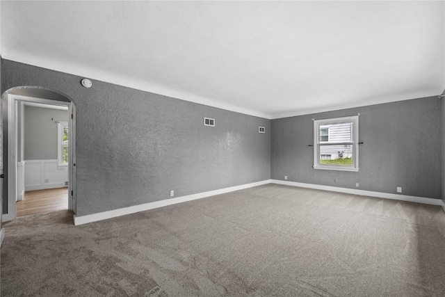 2820 12th Ave SW, Cedar Rapids, IA 52404 - unfurnished room featuring carpet, a textured wall, arched walkways, baseboards, and a smoke detector