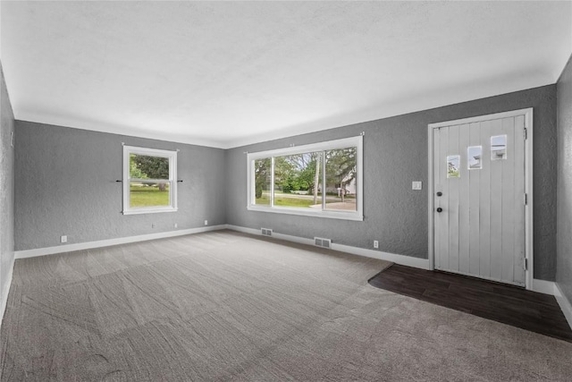 2820 12th Ave SW, Cedar Rapids, IA 52404 - entrance foyer with a textured wall, carpet, and baseboards