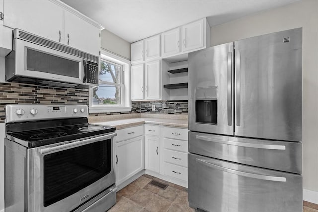 2820 12th Ave SW, Cedar Rapids, IA 52404 - kitchen featuring stainless steel appliances, open shelves, light countertops, backsplash, and white cabinets