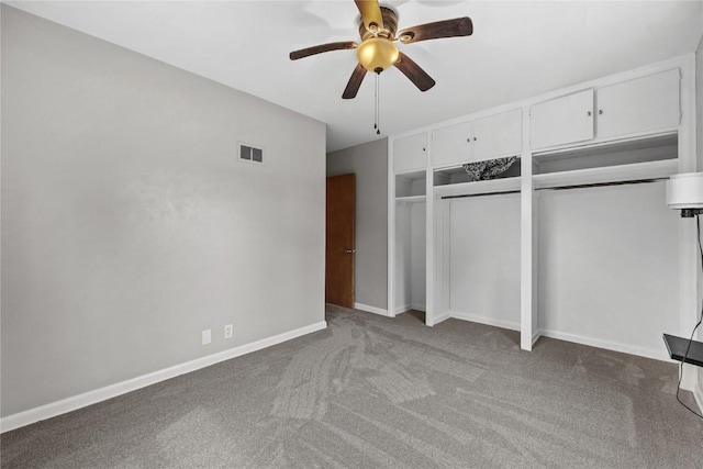 2820 12th Ave SW, Cedar Rapids, IA 52404 - unfurnished bedroom featuring multiple closets, carpet, baseboards, and ceiling fan