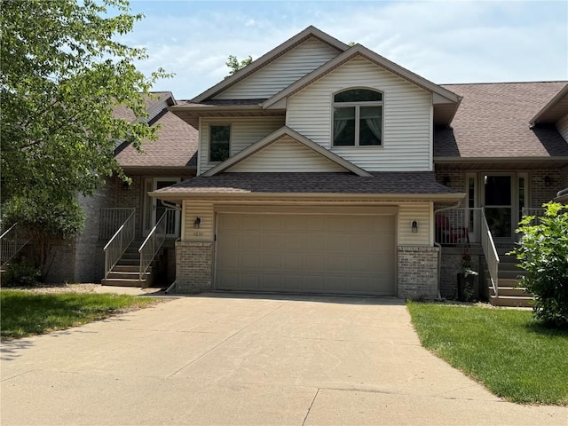 1037 Doubletree Ct NE, Cedar Rapids, IA 52402 - tri-level home with brick siding, concrete driveway, and roof with shingles