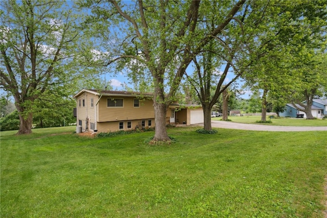 331 Lake View Dr NE, Solon, IA 52333 - tri-level home with concrete driveway, a front lawn, and an attached garage